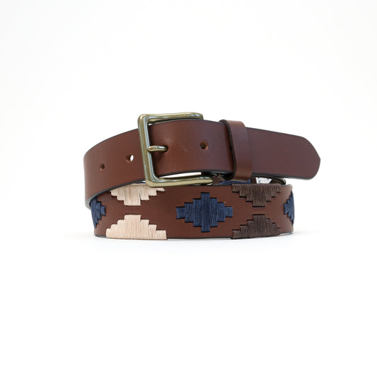 A handmade Italian leather belt with a brown base and blue, white, and tan Aztec woven detailing, finished with a brass-tone buckle.