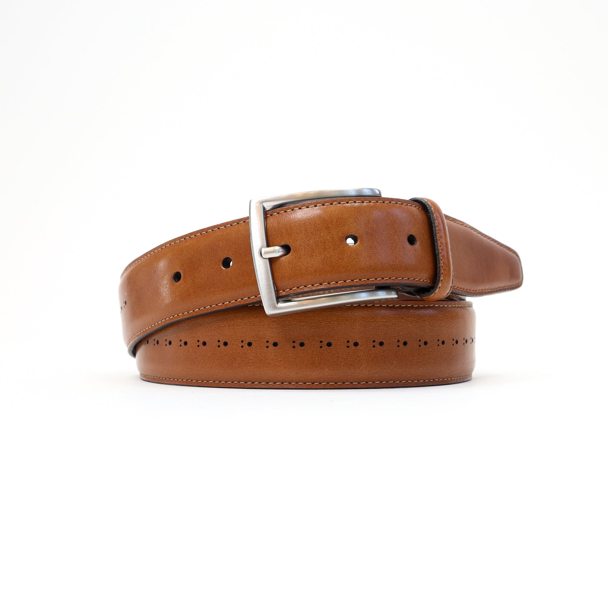 A handmade Italian perforated tan leather belt featuring a silver-tone buckle, elegantly rolled for display.