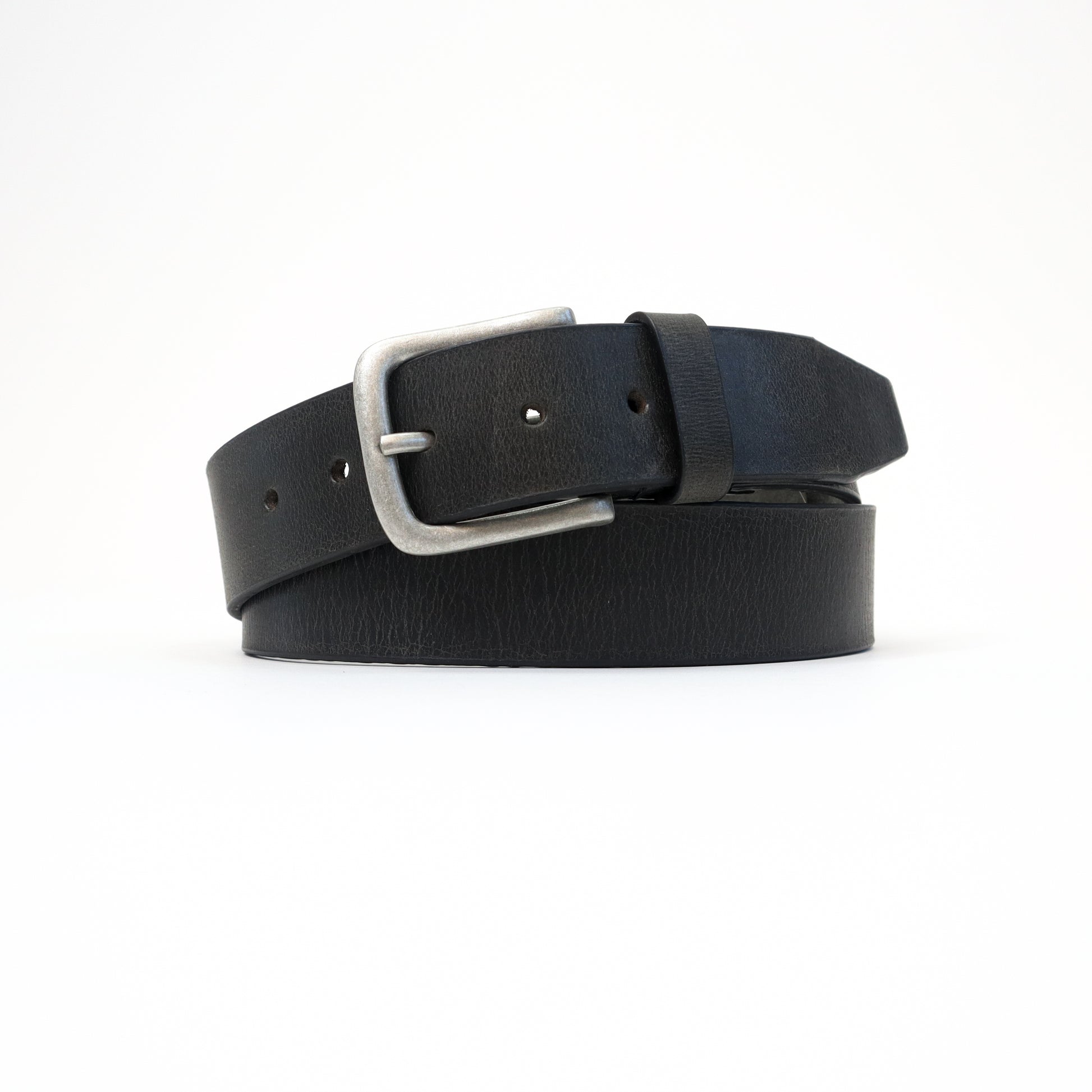 A handmade Italian black leather belt with a silver-tone buckle, neatly rolled for a sophisticated display.