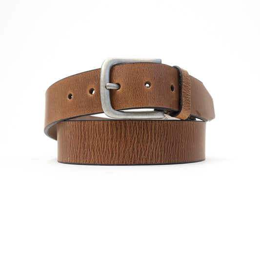 A handmade Italian tan leather belt featuring a silver-tone buckle, elegantly coiled for a refined look
