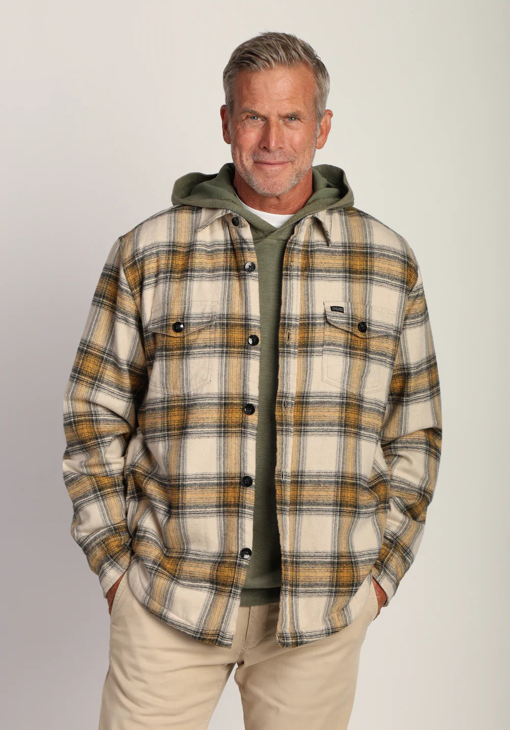 Jackson Plaid Shirt Jacket in Sun colorway layered over a green hoodie, showcasing relaxed fit and classic fall style.