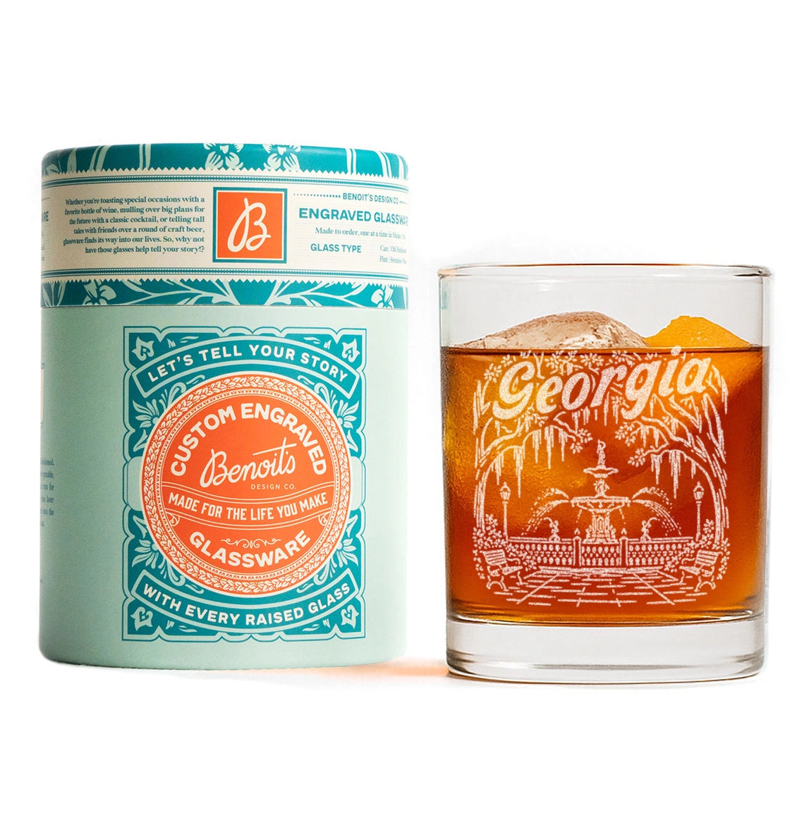 A custom engraved glassware product shown with its branded cylindrical packaging on a white background. The set includes a mint green and teal glass jar labeled 'Georgiana Custom Engraved' alongside a clear rocks glass filled with amber liquid, both featuring white engraved artwork and text.