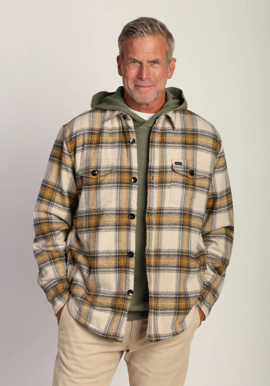 Jackson Plaid Shirt Jacket in Sun colorway layered over a green hoodie, showcasing relaxed fit and classic fall style.