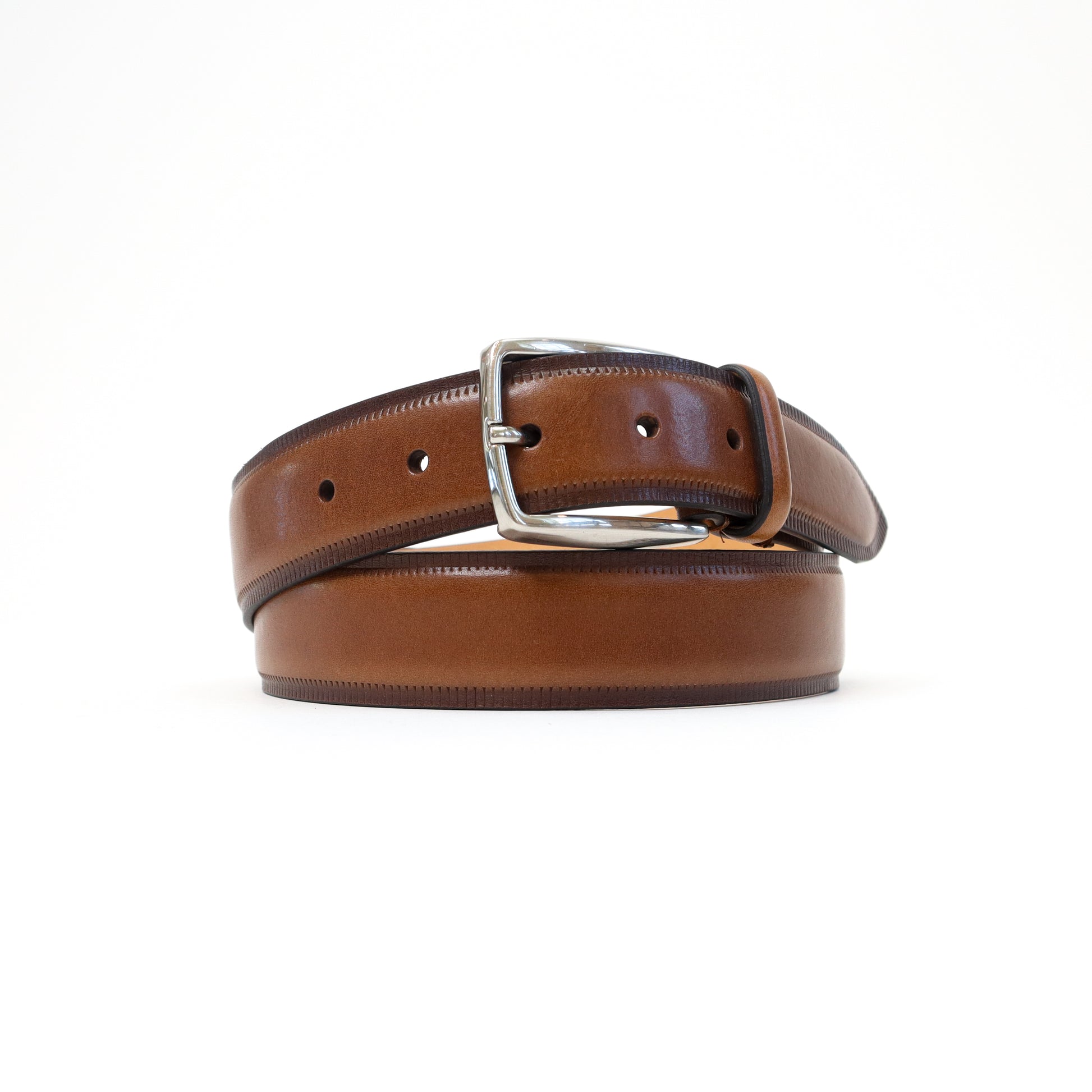 A handmade Italian brown leather belt with a smooth finish and a silver-tone buckle, elegantly rolled for display.
