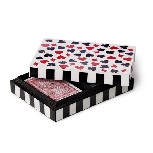 Playing cards with a decorative box featuring heart, club, diamond, and spade symbols.