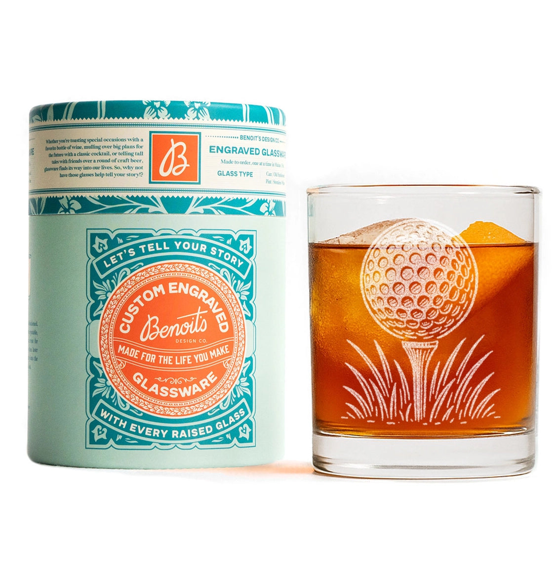 A custom engraved glassware product shown with its branded cylindrical packaging on a white background. The packaging is mint green and teal with an orange circular logo reading 'Let's Tell Your Story: Benoit Glassware'.