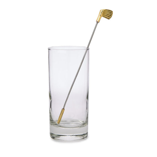 Clear glass with a gold-tipped stirrer on a white background